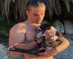 He has adopted a dog named Quavo and cuddles him to show his love.